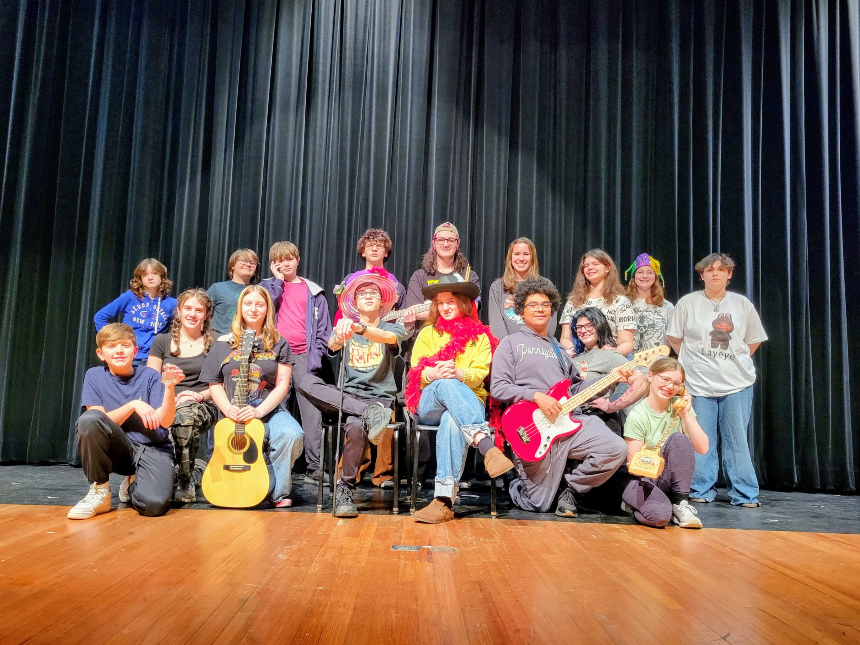 Students participating in this year's talent show pose for a photo on the auditorium stage.